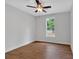 Bedroom with hardwood floors, ceiling fan, and a window overlooking natural surroundings at 12 Cedar Gate Ln, Kingston, GA 30145