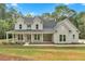 Charming two-story home featuring a covered front porch, landscaped yard, and classic architectural details at 12 Cedar Gate Ln, Kingston, GA 30145
