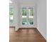Bright foyer with hardwood floors and double glass doors, providing a welcoming entrance to the home at 12 Cedar Gate Ln, Kingston, GA 30145