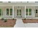 Elegant double doors lead to the entrance, surrounded by large windows and manicured landscaping at 12 Cedar Gate Ln, Kingston, GA 30145