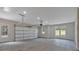 Spacious garage with a door to the outside, windows, and high ceilings at 12 Cedar Gate Ln, Kingston, GA 30145