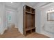 Hallway with a wooden storage unit leading to a bright room and an elegant bathroom at 12 Cedar Gate Ln, Kingston, GA 30145