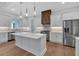 Modern kitchen featuring stainless steel appliances, white cabinets, an island, and stylish pendant lighting at 12 Cedar Gate Ln, Kingston, GA 30145