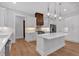 Bright kitchen featuring a wooden vent hood, stainless steel appliances, and a large island with a white countertop at 12 Cedar Gate Ln, Kingston, GA 30145