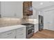 Modern kitchen featuring white cabinets, stainless appliances, wooden accents, and tile backsplash at 12 Cedar Gate Ln, Kingston, GA 30145