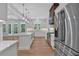 Spacious kitchen with a wooden vent hood, stainless steel appliances, and a white kitchen island at 12 Cedar Gate Ln, Kingston, GA 30145