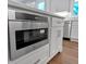 Kitchen island with stainless steel microwave and white countertops at 12 Cedar Gate Ln, Kingston, GA 30145