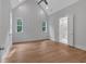 Bright primary bedroom featuring windows, wooden floors, and an ensuite bathroom at 12 Cedar Gate Ln, Kingston, GA 30145