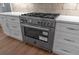 The kitchen features white cabinets, stainless appliances and a gas cooktop at 12 Cedar Gate Ln, Kingston, GA 30145