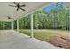 Large covered patio with concrete floor, white pillars, and ceiling fans at 12 Cedar Gate Ln, Kingston, GA 30145