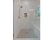 Contemporary shower features marble walls, a built-in seat, and a shower niche for storage at 12 Cedar Gate Ln, Kingston, GA 30145