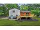 A view of the back of the home showing a new deck and stairs at 1355 Tucker Woods Dr, Norcross, GA 30093