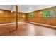 Spacious finished basement featuring wood-look flooring, wood paneling, and natural light at 1355 Tucker Woods Dr, Norcross, GA 30093