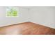 Bright bedroom with hardwood floors and a large window providing natural light at 1355 Tucker Woods Dr, Norcross, GA 30093