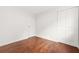 Bright bedroom featuring hardwood floors, white walls, and a closet with folding doors at 1355 Tucker Woods Dr, Norcross, GA 30093