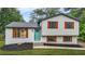 Charming two-story home featuring a freshly painted exterior and colorful shutters for added curb appeal at 1355 Tucker Woods Dr, Norcross, GA 30093
