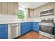 Modern kitchen featuring stainless steel appliances, light countertops and stylish two-tone cabinetry at 1355 Tucker Woods Dr, Norcross, GA 30093