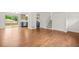 Open-concept dining and living area with hardwood floors and sliding glass doors to deck at 1355 Tucker Woods Dr, Norcross, GA 30093