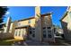 Backyard featuring a concrete patio, a grass lawn, a tall chimney and plenty of windows at 2275 Copper Trail Ln, Buford, GA 30519