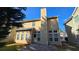 Backyard featuring a concrete patio, a grass lawn, a tall chimney and plenty of windows at 2275 Copper Trail Ln, Buford, GA 30519