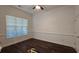 Well-appointed bedroom featuring fresh paint, hardwood floors, and soft natural light from the large window at 2275 Copper Trail Ln, Buford, GA 30519