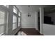 Charming dining room with dark hardwood floors, wainscoting, and bright windows creates a warm and inviting atmosphere at 2275 Copper Trail Ln, Buford, GA 30519