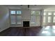 This living room has a beautiful fireplace, hardwood floors, and large windows which provide plenty of natural light at 2275 Copper Trail Ln, Buford, GA 30519