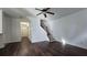 Open living room with hard wood floors, staircase, and a ceiling fan at 2275 Copper Trail Ln, Buford, GA 30519