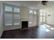 Open living area has a cozy fireplace, hardwood floors, and a wall of windows for bright, natural lighting at 2275 Copper Trail Ln, Buford, GA 30519