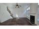 Living room with hardwood flooring, a fireplace, stairs with wood and metal railings, and windows with blinds at 2275 Copper Trail Ln, Buford, GA 30519