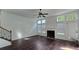 Bright living room featuring a fireplace, hardwood floors, and natural light streaming through large windows at 2275 Copper Trail Ln, Buford, GA 30519