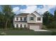 Charming two-story home with a brick foundation and gray wood siding, complemented by a well-manicured lawn and mature trees at 2481 Cotton Ln, Douglasville, GA 30135