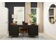 Well-lit home office featuring a dark wood desk, comfortable chair, and stylish decor at 2481 Cotton Ln, Douglasville, GA 30135