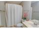 Bright, modern bathroom features sleek fixtures, crisp white cabinets, and a shower-tub combo offering both style and functionality at 3381 Grovewood Ln, Duluth, GA 30096