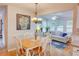 Open dining area with wood table, chandelier, and view into the sunny living room at 3381 Grovewood Ln, Duluth, GA 30096