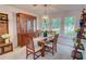 Bright dining room with wood table set, hutch, and decorative chandelier at 3381 Grovewood Ln, Duluth, GA 30096