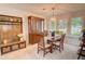 Bright dining room with wood table, chandelier, and built-in storage at 3381 Grovewood Ln, Duluth, GA 30096