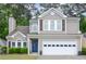 Charming two-story home featuring a blue front door, two-car garage, well-manicured lawn and traditional architectural details at 3381 Grovewood Ln, Duluth, GA 30096