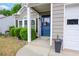 Inviting entrance showcasing blue front door, verdant shrubs, and well-kept front porch in a traditional-style home at 3381 Grovewood Ln, Duluth, GA 30096