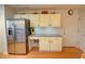 Well-lit kitchen boasts stainless steel refrigerator, granite counters, and warm wood flooring at 3381 Grovewood Ln, Duluth, GA 30096