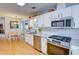 Bright, modern kitchen with stainless appliances, granite countertops, and wood floors at 3381 Grovewood Ln, Duluth, GA 30096