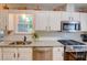 Modern kitchen with granite countertops, stainless steel appliances, and subway tile at 3381 Grovewood Ln, Duluth, GA 30096