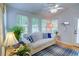 Bright sunroom with a white sofa, blue accents, and plenty of natural light at 3381 Grovewood Ln, Duluth, GA 30096