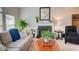 Cozy living room with a fireplace, neutral decor, plants, and comfortable furnishings creating a welcoming ambiance at 3381 Grovewood Ln, Duluth, GA 30096