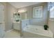 Elegant bathroom features a luxurious soaking tub, and modern fixtures perfect for relaxation and rejuvenation at 3381 Grovewood Ln, Duluth, GA 30096