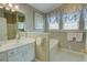 Charming bathroom features a soaking tub, crisp white cabinets, and tasteful decor creating a spa-like retreat at 3381 Grovewood Ln, Duluth, GA 30096