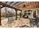 Backyard patio with a pergola, ceiling fan and comfortable seating at 4120 Winterberry Rd, Cumming, GA 30040