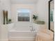 Relaxing bathroom with a soaking tub and decorative accents at 4120 Winterberry Rd, Cumming, GA 30040