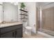 Modern bathroom with granite countertop, glass-enclosed shower, and stylish shelving at 4120 Winterberry Rd, Cumming, GA 30040
