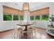 Charming dining area with natural light, a wooden table, and a stylish chandelier at 4120 Winterberry Rd, Cumming, GA 30040
